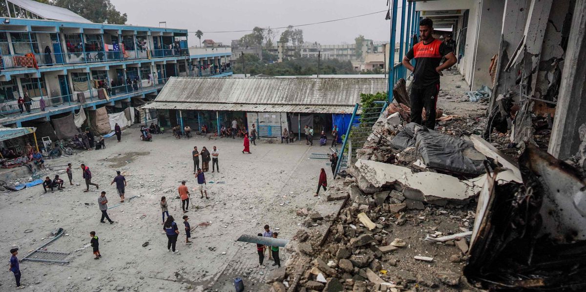Palestinians check a UN-school housing displacing people that was hit during Israeli bombardment in Nuseirat, in the central Gaza Strip, on June 6, 2024, amid the ongoing conflict between Israel and the Palestinian Hamas militant group. The Israeli military said on June 6 its fighter jets had struck a UN-run school used by Palestinian militants in central Gaza, with authorities in the Hamas-run territory reporting at least 27 dead. (Photo by Bashar TALEB / AFP)