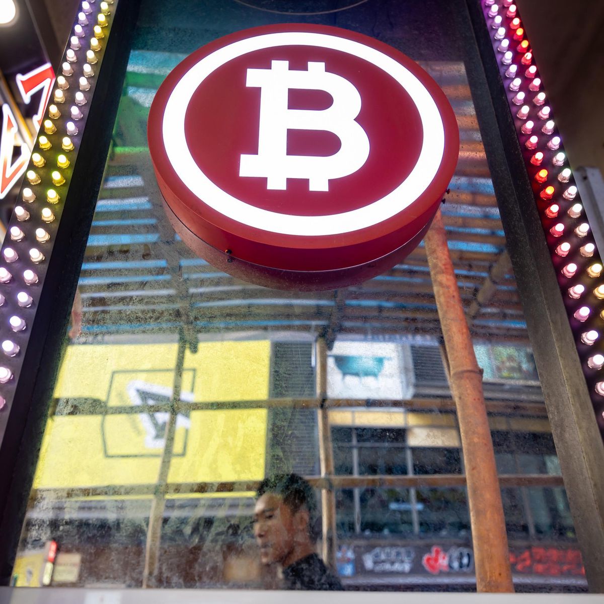Signage for Bitcoin in Hong Kong, China, on Tuesday, Nov. 12, 2024. Bitcoin's record-breaking rally took the digital asset past $89,000 and lifted the overall value of the crypto market above its pandemic-era peak as traders bet on a boom under President-elect Donald Trump. Photographer: Paul Yeung/Bloomberg