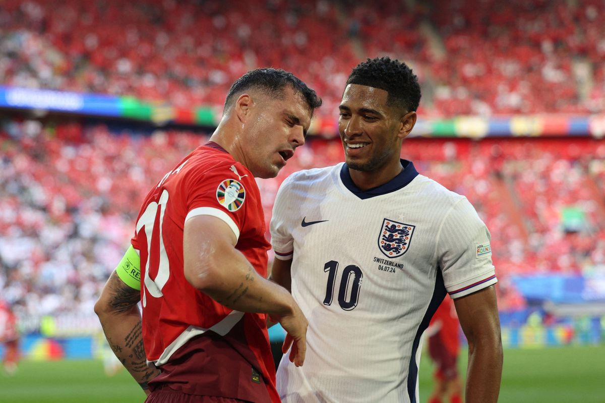 Switzerland's midfielder #10 Granit Xhaka (L) reacts next to England's midfielder #10 Jude Bellingham during the UEFA Euro 2024 quarter-final football match between England and Switzerland at the Duesseldorf Arena in Duesseldorf on July 6, 2024. (Photo by Adrian DENNIS / AFP)