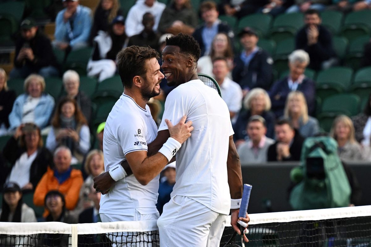 France's Gael Monfils (R) laughs with Switzerland's Stan Wawrinka (L) during their men's singles second round tennis match on the third day of the 2024 Wimbledon Championships at The All England Lawn Tennis and Croquet Club in Wimbledon, southwest London, on July 3, 2024. (Photo by Ben Stansall / AFP) / RESTRICTED TO EDITORIAL USE