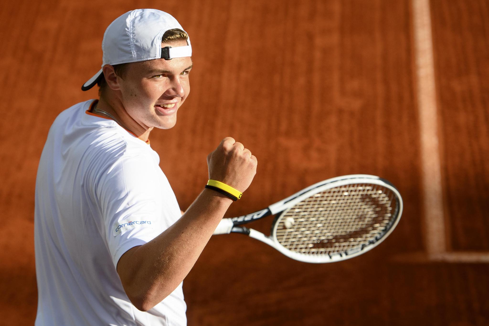 Dominic Stephan Stricker of Switzerland returns a ball to Marton Fucsovics of Hungaria during their round of 16 (1/8 final) men's match, at the ATP 250 Geneva Open tournament in Geneva, Switzerland, Wednesday, May 19, 2021. The matches of the Geneva Open are played in front of 100 spectators due to preventive measure against the spread the coronavirus COVID-19. (KEYSTONE/Laurent Gillieron)