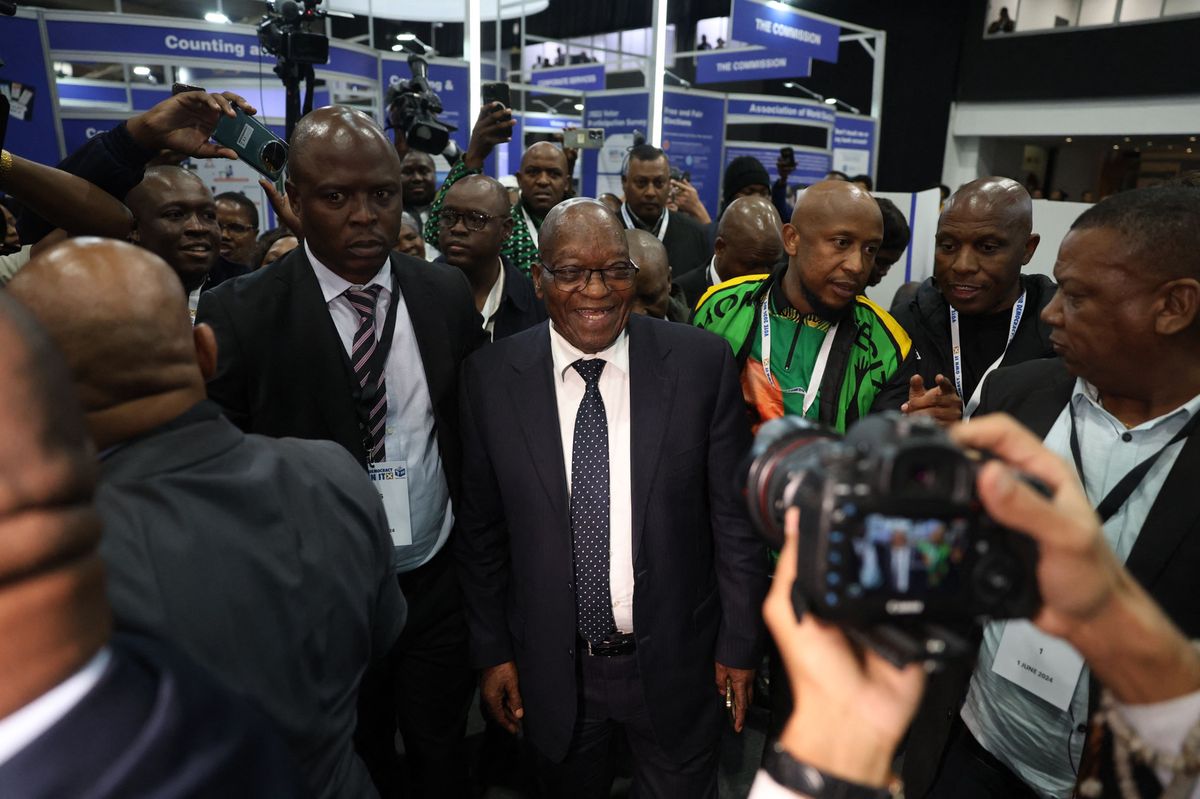 Former South African President and uMkhonto weSizwe (MK) Party leader Jacob Zuma (C) smiles as he arrives at the Independent Electoral Commission (IEC) National Results Center in Midrand on June 1, 2024. South Africa's ruling ANC faced a search for allies to help it form a new government Saturday after it lost its three-decade-old absolute majority in a watershed election. 
With 99 percent of the votes from Wednesday's election counted, President Cyril Ramaphosa's African National Congress had only 40 percent, a catastrophic slump from the 57.5 it won in 2019. (Photo by PHILL MAGAKOE / AFP)