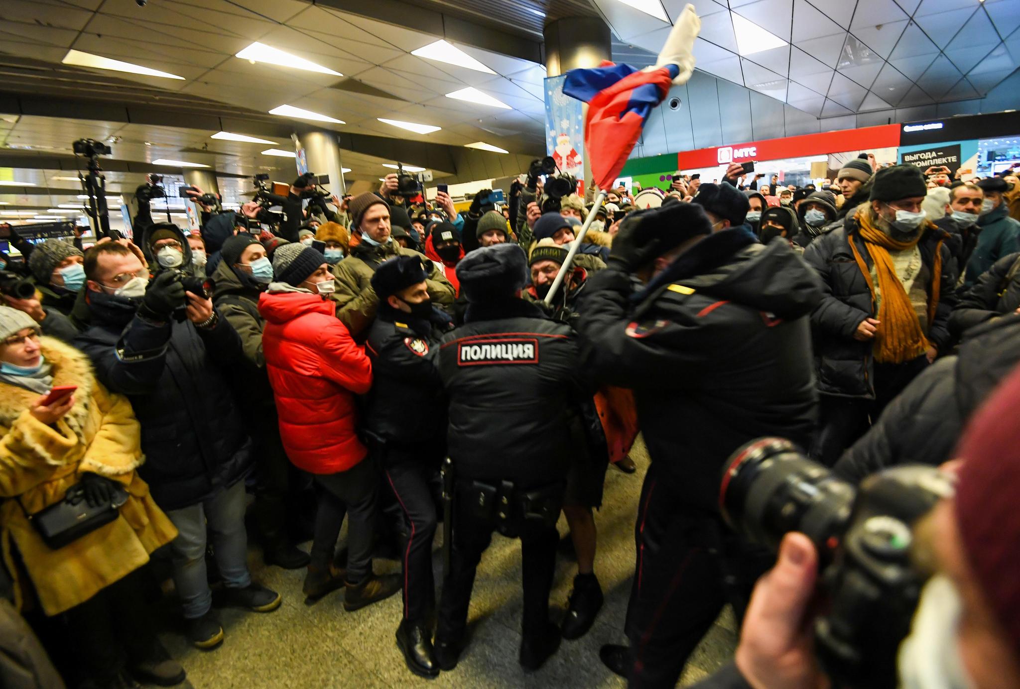 Des policiers arrêtent un partisan d’Alexeï Navalny à l’aéroport de Moscou Vnukovo (17 janvier 2021).