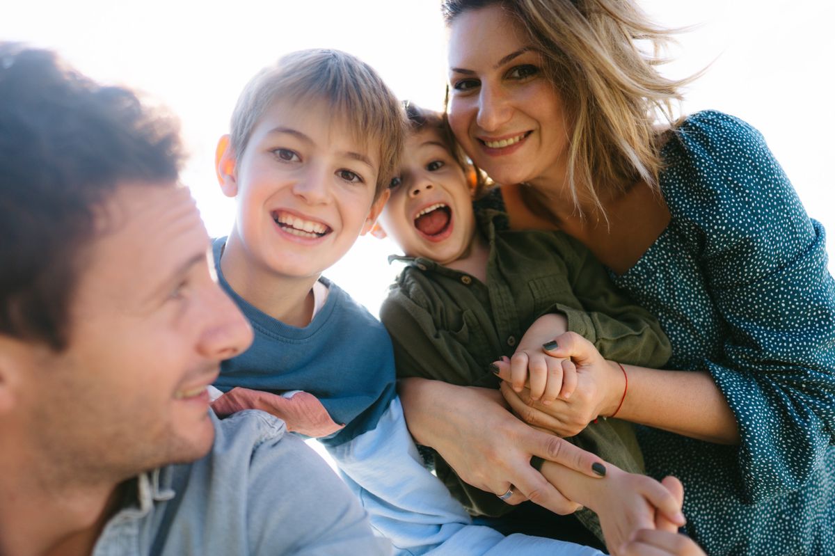 Photo of a smiling family taking a selfie