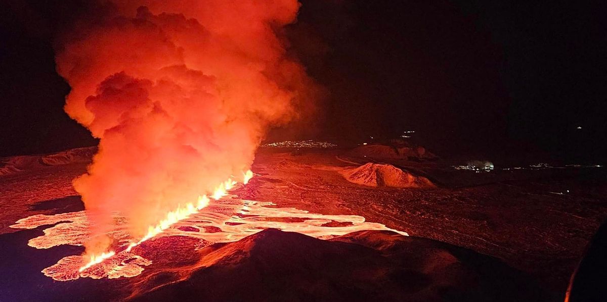 Billowing smoke and flowing lava are seen pouring out of a new fissure in this Icelandic Department of Civil Protection and Emergency Management , February 8, 2024, handout image during a new volcanic eruption on the outskirts of the evacuated town of Grindavik, western Iceland. A volcanic eruption started on the Reykjanes peninsula in southwestern Iceland on Thursday, the third to hit the area since December, authorities said. (Photo by Icelandic Department of Civil Protection and Emergency Management / AFP)