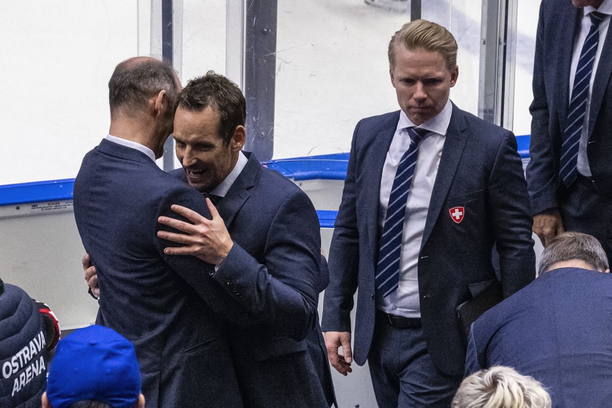 Switzerland's Headcoach Patrick Fischer, center, and assistant coach Manuel Linger, right, celebrate their victory during the Ice Hockey World Championship quarter final match between Switzerland and Germany in Ostrava at the Ostravar Arena, Czech Republic, on Thursday, May 23, 2024. (KEYSTONE/Peter Schneider)