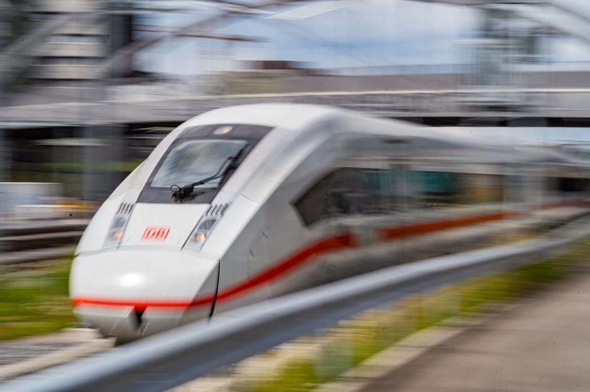 A high-speed train of Deutsche​ Bahn on a railway line.