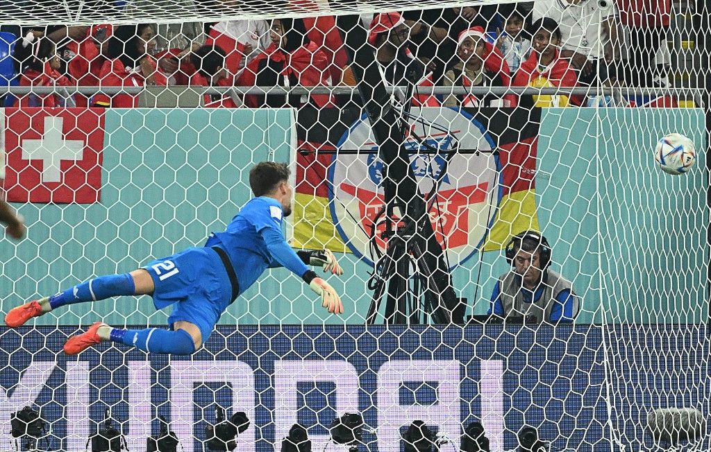 Switzerland's goalkeeper #21 Gregor Kobel concedes a goal by Serbia's forward #09 Aleksandar Mitrovic during the Qatar 2022 World Cup Group G football match between Serbia and Switzerland at Stadium 974 in Doha on December 2, 2022. (Photo by Ina Fassbender / AFP)