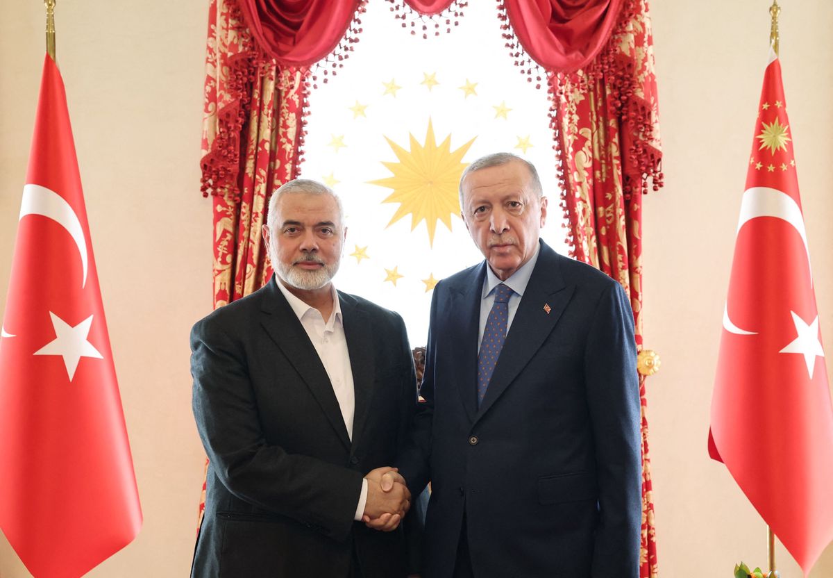 This handout photograph taken and released by Turkish Presidency Press Office on April 20, 2024, shows Turkish President Recep Tayyip Erdogan (R) shaking hands with Ismail Haniyeh, the political leader of the Palestinian movement Hamas, at the Dolmabahce Presidential working office in Istanbul. Hamas political leader Ismail Haniyeh began talks with Turkey's President Recep Tayyip Erdogan in Istanbul on Apil 20, 2024, as Middle East tensions run high, Turkish media reported. (Photo by Handout / TURKISH PRESIDENTIAL PRESS SERVICE / AFP) / RESTRICTED TO EDITORIAL USE - MANDATORY CREDIT "AFP PHOTO / TURKISH PRESIDENCY PRESS OFFICE" - NO MARKETING NO ADVERTISING CAMPAIGNS - DISTRIBUTED AS A SERVICE TO CLIENTS