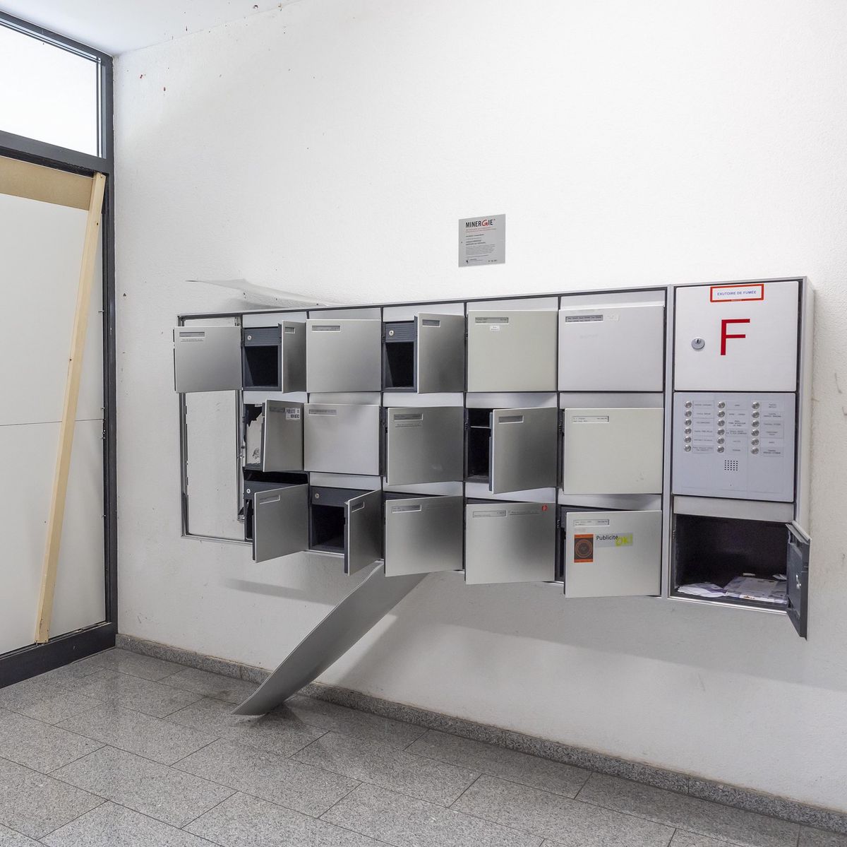 Vue des boîtes aux lettres endommagées après l’explosion d’un colis piégé dans un immeuble à Genève, près du chemin de la Petite-Boissière, blessant grièvement une fillette.