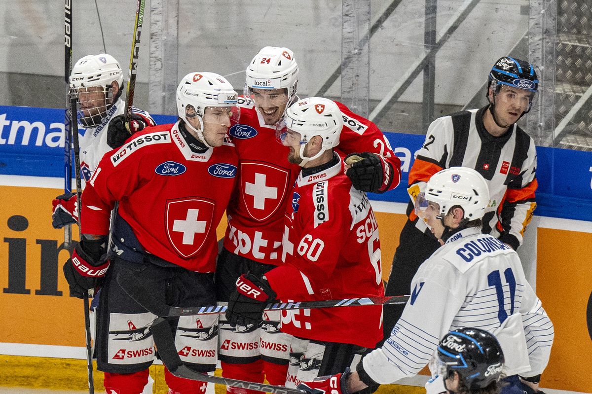 Switzerland's Sven Senteler, Tobias Geisser and Tristan Scherwey, from left, celebrate their scores to 3-2 during an ice hockey World Cup preparation match between Switzerland and France at the St. Jakob-Arena in Basel, Switzerland, on Saturday, April 20, 2024. (KEYSTONE/Peter Schneider)