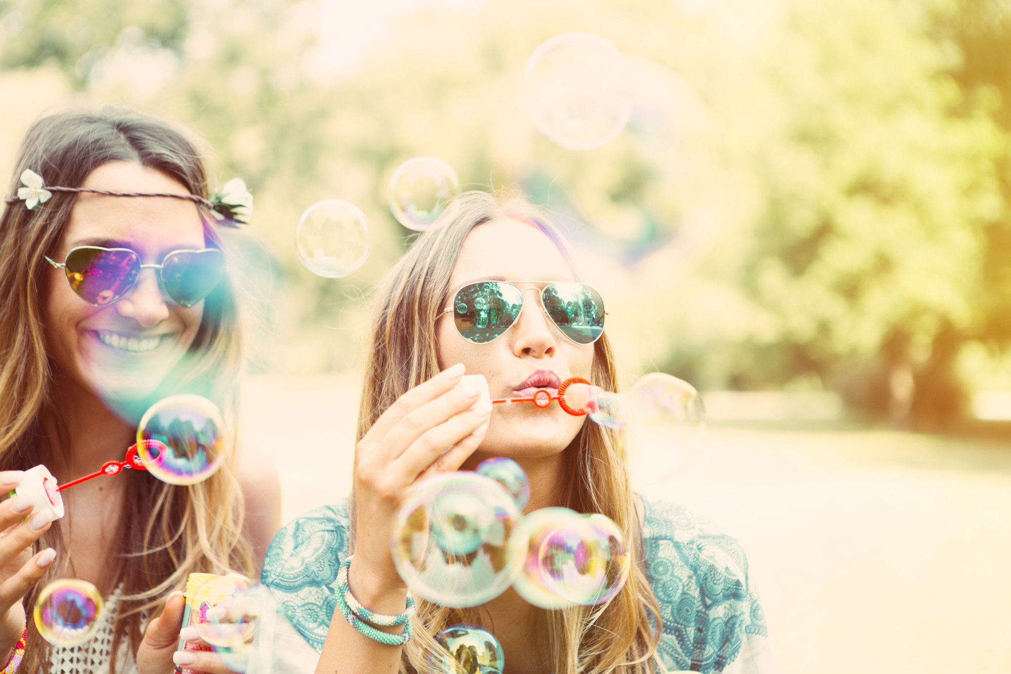 twin sisters making soap bubbles. summer feeling