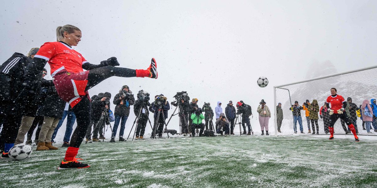 Team Switzerland Ambassador Lara Dickenmann (L) shoots a penalty kick to Team Switzerland Ambassador Swiss footballer Kathrin Lehmann (R) on a pitch set at 3,454m above sea level in Aletsch glacier in the Swiss Alps, during an event launching the ticket sales for UEFA Women’s EURO 2025 football tournament, at the Jungfraujoch, on October 1, 2024. 16 national football teams will play a total of 31 matches in eight host cities across Switzerland over a four-week period from 2 to 27 July 2025, (Photo by Fabrice COFFRINI / AFP)