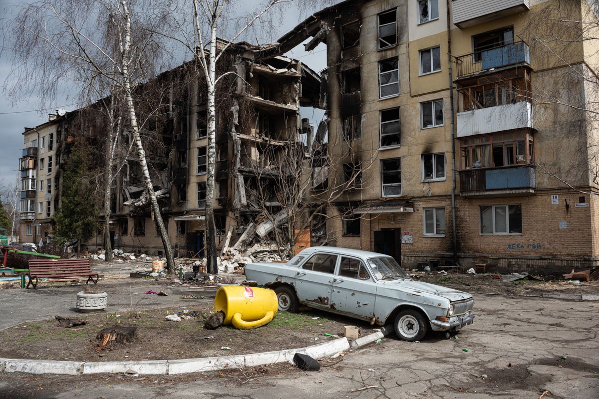 HOSTOMEL, UKRAINE - APRIL 06: A damaged car is seen next to a heavily damaged apartment building on April 6, 2022 in Hostomel, Ukraine. Hostomel was occupied for more than a month by Russian forces as they pushed toward the Ukrainian capital, before ultimately retreating to Belarus last week. (Photo by Alexey Furman/Getty Images) *** BESTPIX ***