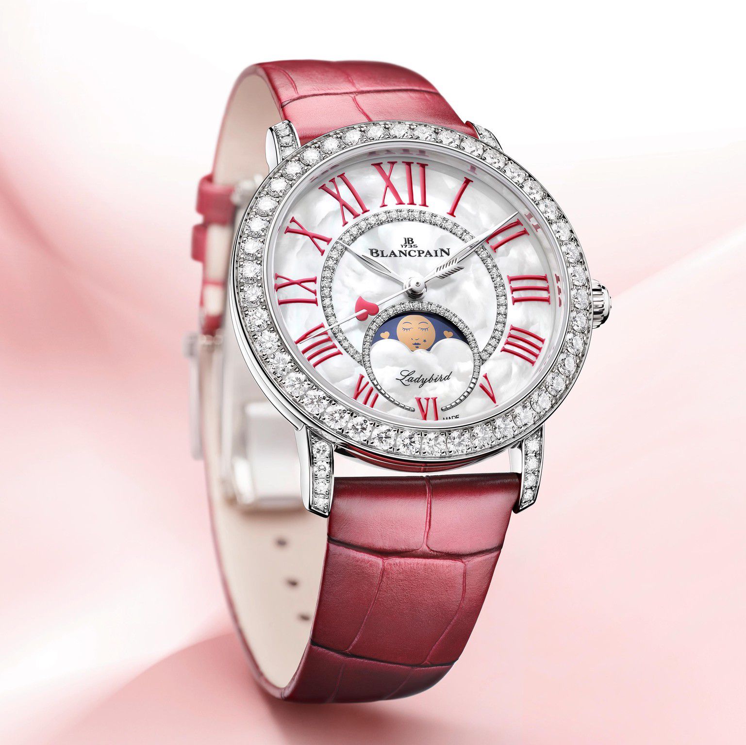 Montre élégante Blancpain avec bracelet rose et cadran orné de diamants, affichant des chiffres romains rouges et une phase de lune.