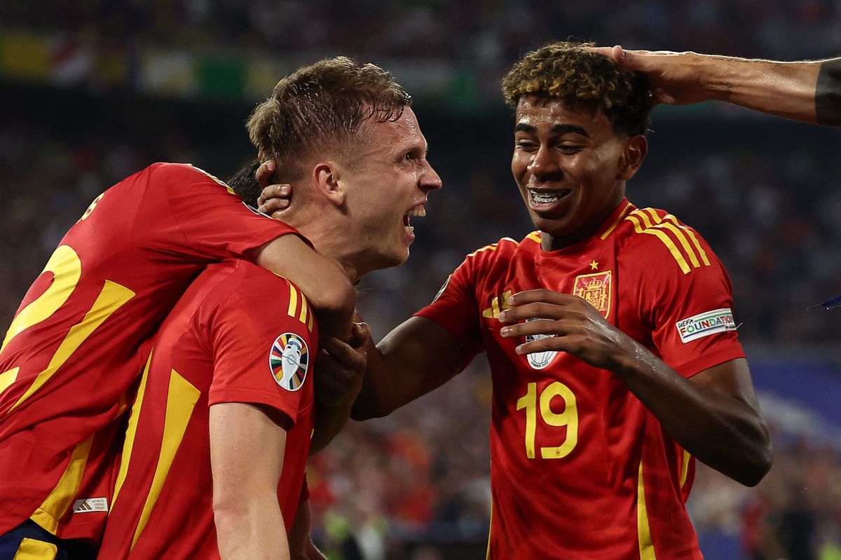 Spain's forward #10 Daniel Olmo (C) celebrates with Spain's forward #19 Lamine Yamal France's own goal and Spain's second goal following his kick during the UEFA Euro 2024 semi-final football match between Spain and France at the Munich Football Arena in Munich on July 9, 2024. (Photo by FRANCK FIFE / AFP)