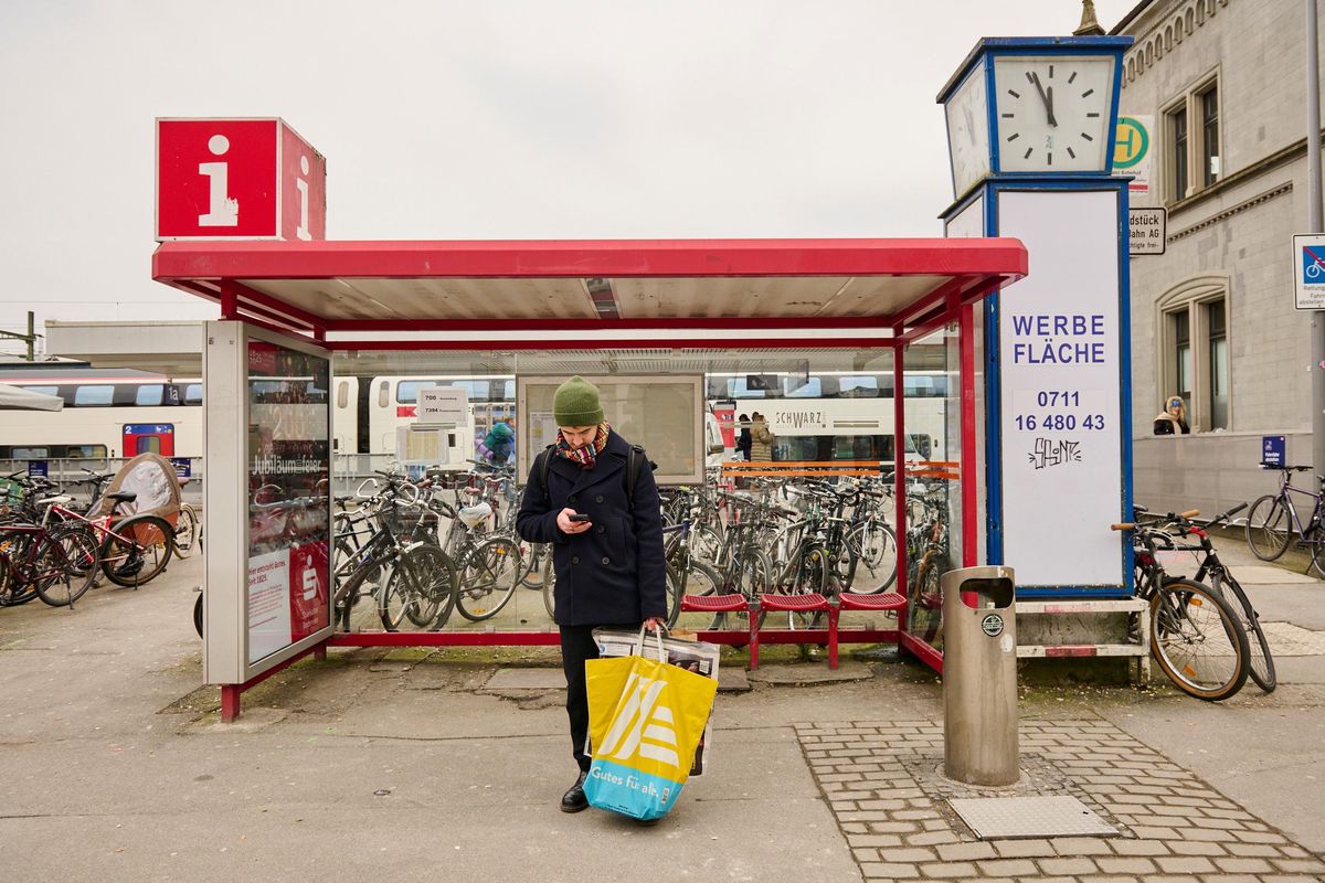 A‌ person with a shopping bag leaves a train station in ⁤Germany.