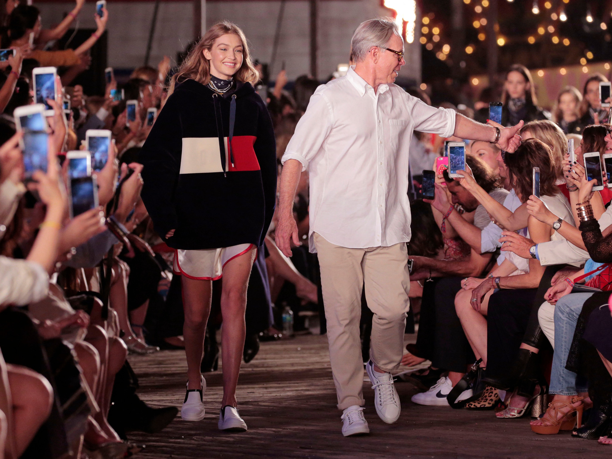 NEW YORK, NY - SEPTEMBER 09: Model Gigi Hadid (L) and designer Tommy Hilfiger walk the runway at #TOMMYNOW Women's Fashion Show during New York Fashion Week at Pier 16 on September 9, 2016 in New York City.   Randy Brooke/Getty Images for Tommy Hilfiger/AFP (Photo by Randy Brooke / GETTY IMAGES NORTH AMERICA / Getty Images via AFP)