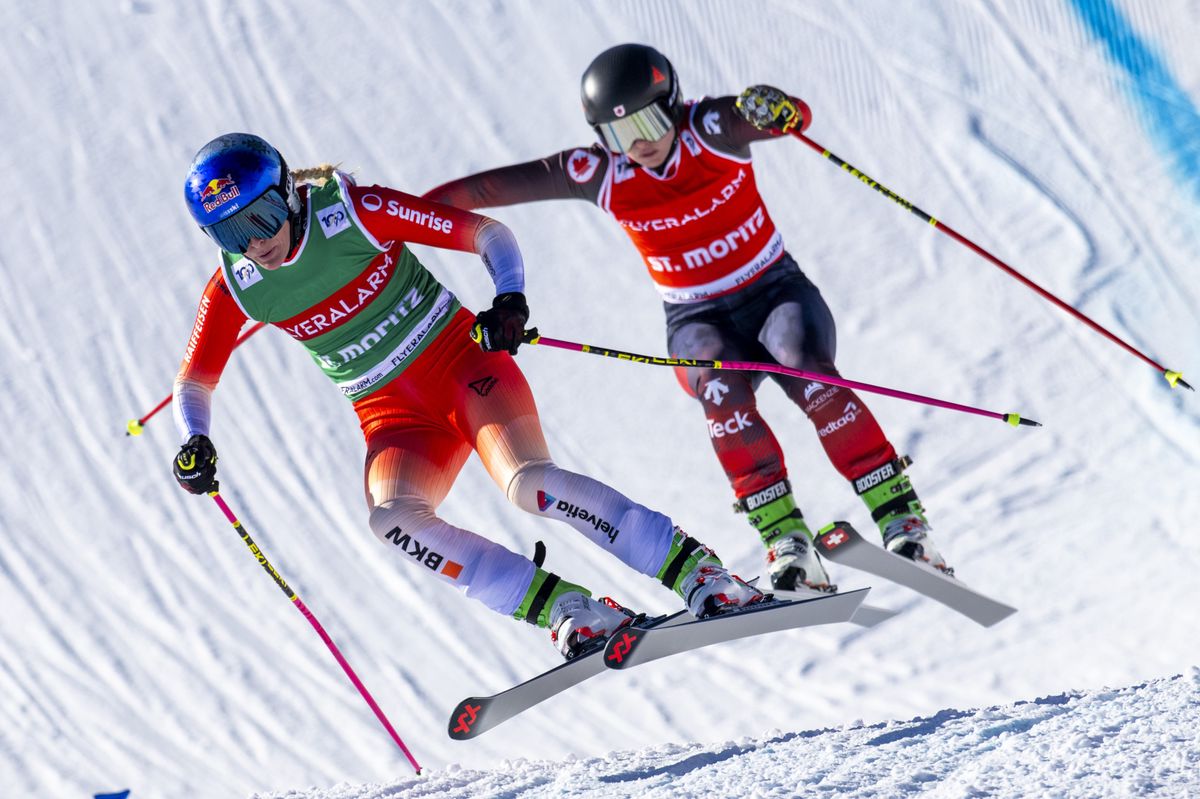 Fanny Smith of Switzerland, left, speeds down the track at the Ski Cross World Cup race in St. Moritz, Switzerland, on Sunday, January 28, 2024. (KEYSTONE/Mayk Wendt)