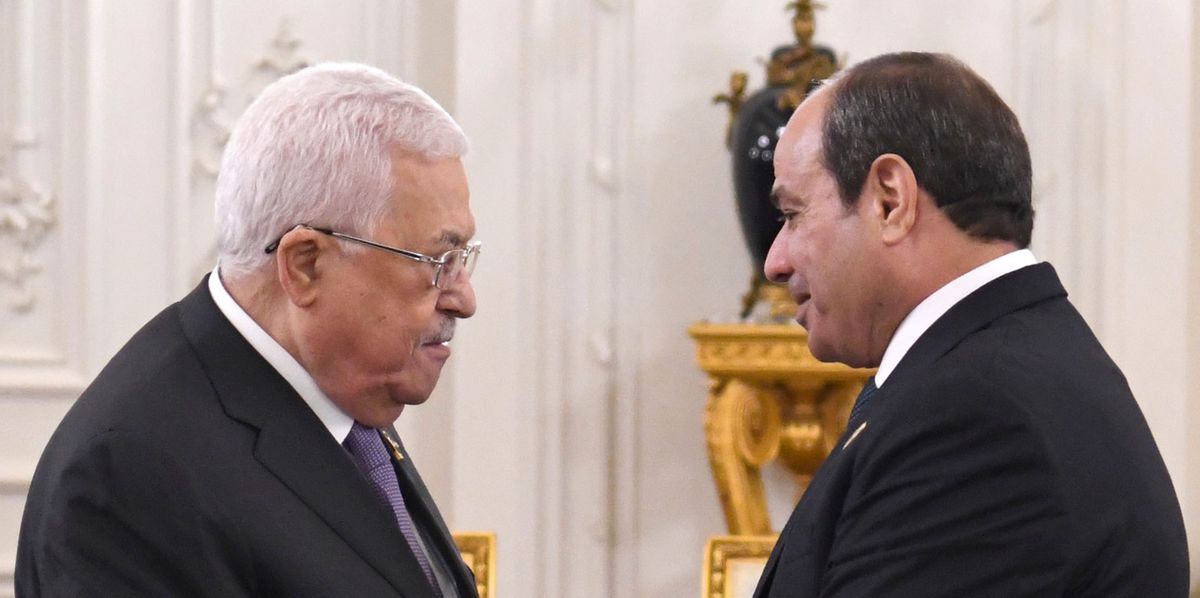In this photo provided by Egypt's presidency media office, Egyptian President Abdel Fattah el-Sissi, right, greets Palestinian President Mahmoud Abbas, during the International peace summit pose for a group picture at the New Administrative Capital, just outside Cairo, Egypt, Saturday, Oct. 21, 2023. (Egyptian Presidency Media Office via AP)