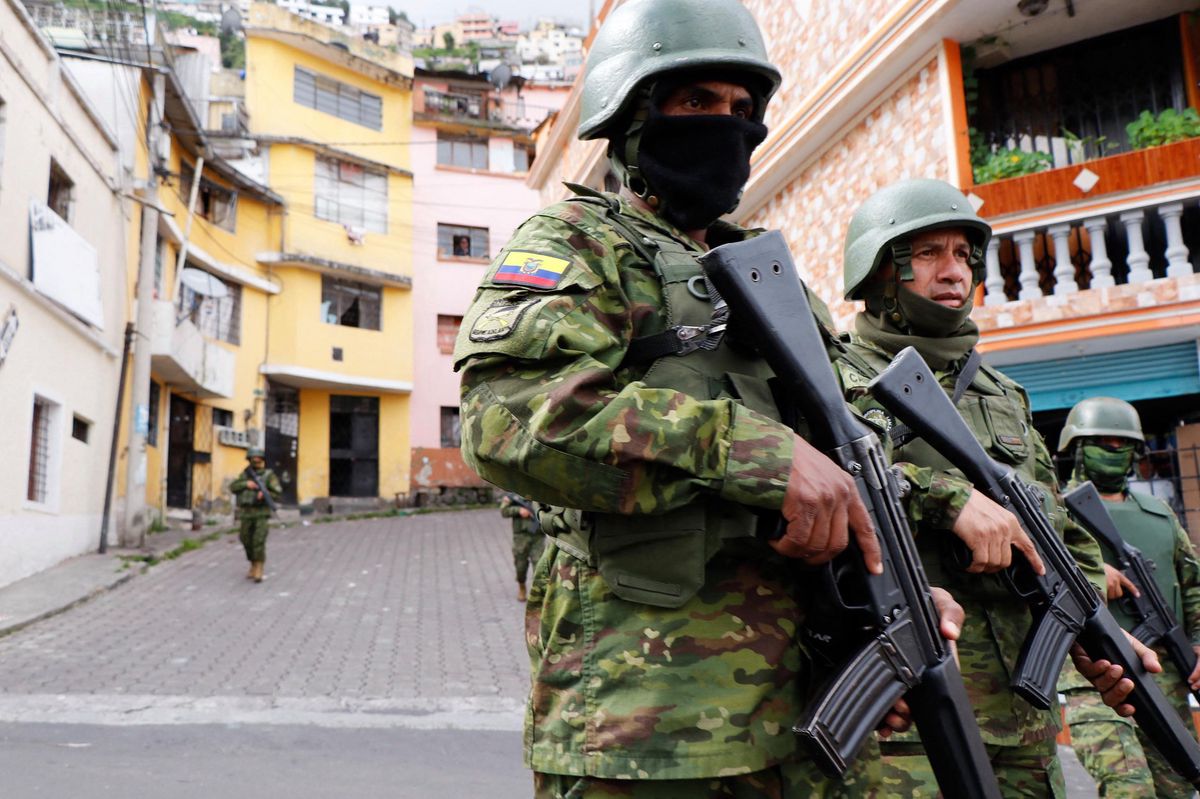 Members of the Armed Forces patrol a street during an operation to protect civil security in Quito, on January 10, 2024. Ecuador's president Daniel Noboa gave orders on Tuesday to "neutralize" criminal gangs after gunmen stormed and opened fire in a TV studio, as bandits threatened random executions on a second day of terror in the country. Gangs declared war on the government after Noboa announced a state of emergency following the prison escape on January 7 of one of Ecuador's most powerful narco bosses. (Photo by STRINGER / AFP)