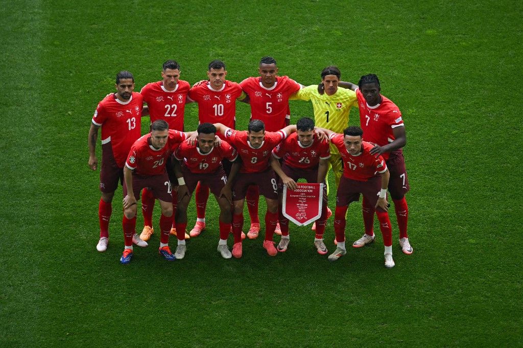 (From L) Switzerland's defender #13 Ricardo Rodriguez, Switzerland's midfielder #20 Michel Aebischer, Switzerland's defender #22 Fabian Schaer, Switzerland's forward #19 Dan Ndoye, Switzerland's midfielder #10 Granit Xhaka, Switzerland's midfielder #08 Remo Freuler, Switzerland's defender #05 Manuel Akanji, Switzerland's midfielder #26 Fabian Rieder, Switzerland's goalkeeper #01 Yann Sommer, Switzerland's midfielder #17 Ruben Vargas and Switzerland's forward #07 Breel Embolo pose prior to the UEFA Euro 2024 quarter-final football match between England and Switzerland at the Duesseldorf Arena in Duesseldorf on July 6, 2024. (Photo by OZAN KOSE / AFP)