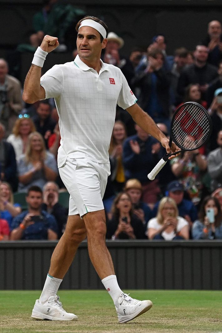 TOPSHOT - Switzerland's Roger Federer celebrates his victory over Britain's Cameron Norrie during their men's singles third round match on the sixth day of the 2021 Wimbledon Championships at The All England Tennis Club in Wimbledon, southwest London, on July 3, 2021. (Photo by Ben STANSALL / AFP) / RESTRICTED TO EDITORIAL USE