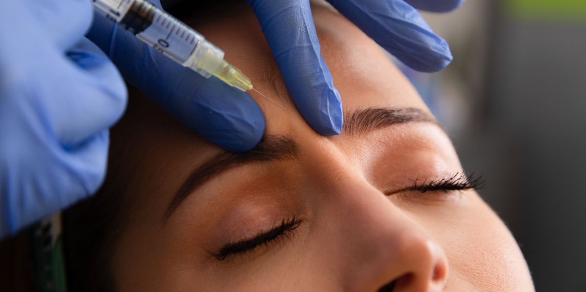 Young woman receiving a botox injection