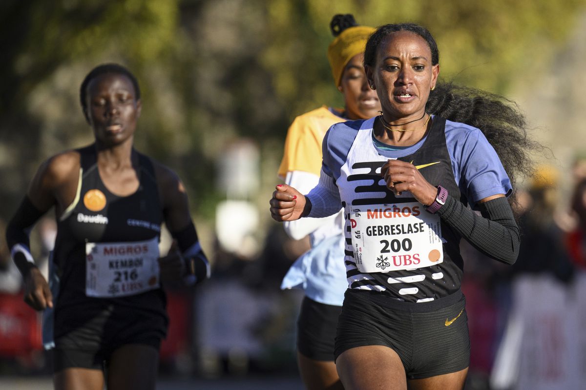 First placed Gotytom Gebreslase, of Ethiopia,  foreground, third placed Judy Kemboi, left, of Kenya and second placed Ayenew Baze, background right, of Ethiopia compete in the women's elite category during the 45th Escalade Race (Course de l'Esacalde) in Geneva, Switzerland, Sunday, Dec. 3, 2023. (Laurent Gillieron/Keystone via AP)