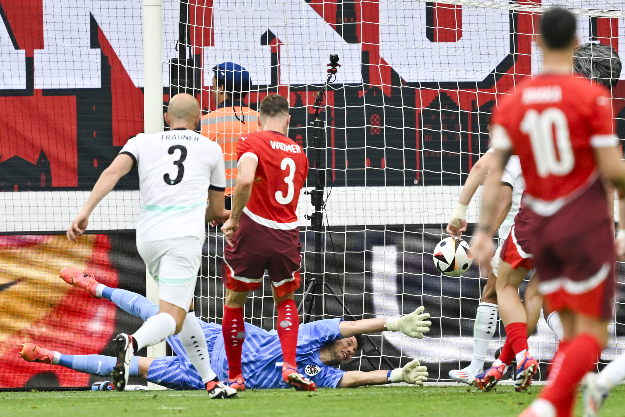 Switzerland's Silvan Widmer scores 1-1 versus Austria's goalkeeper Heinz Lindner, during an international friendly soccer match between Switzerland and Austria at the kybunpark stadium in St. Gallen, Switzerland, Saturday, June 8, 2024. (KEYSTONE/Gian Ehrenzeller)