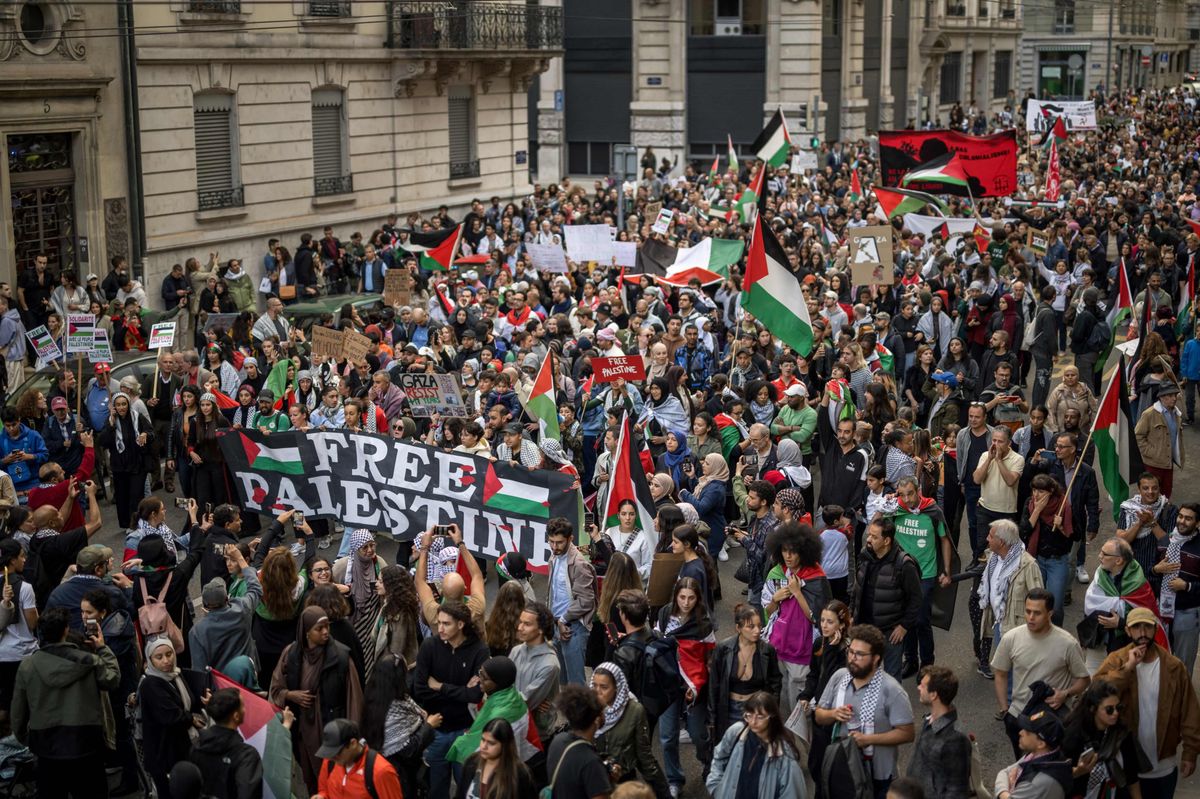 Protester wave Palestinian flags during a rally in support of Palestinians in Geneva, on October 14, 2023. Gunmen from the Islamist Hamas burst across the Gaza border with Israel on October 7 and shot dead more than 1,300 people, including civilians. In response, Israel has mounted a withering campaign of air and artillery strikes on Gaza that has killed more than 2,200 people, including over 700 children. (Photo by Fabrice COFFRINI / AFP)