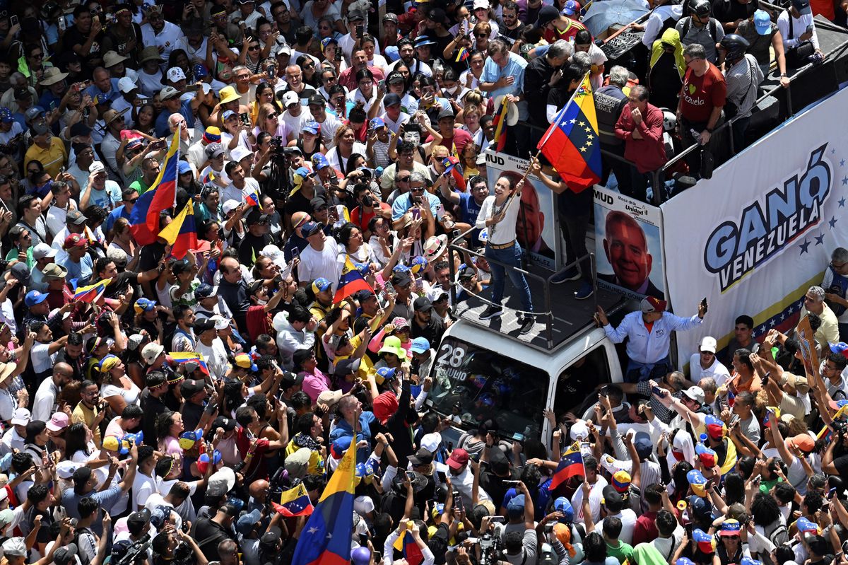 Maria Corina Machado holds a Venezuelan flag in Caracas, Saturday, Aug. 17, 2024.