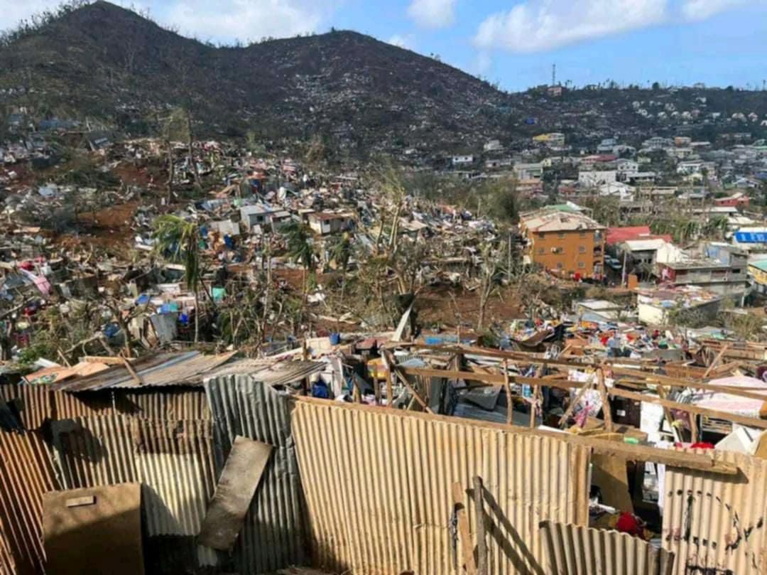 This photograph shows destroyed building after the cyclone Chido hit France's Indian Ocean territory of Mayotte, on December 14, 2024 in the capital Mamoudzou. At least 14 people were killed in Mayotte when a fierce cyclone battered the French Indian Ocean territory, authorities said on December 15, 2024, with officials warning it will take days to know the full toll. (Photo by Daniel MOUHAMADI / AFP)