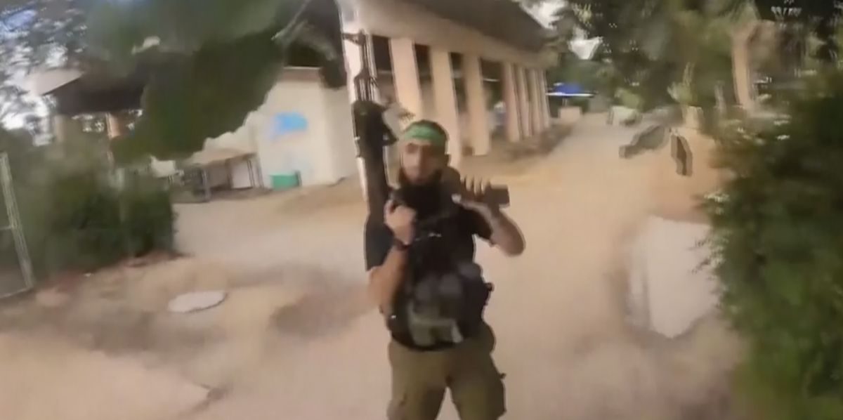 This image made from undated bodycam video footage taken by a downed Hamas militant and released by Israel Defense Forces shows a Hamas militant walking around a residential neighborhood at an undisclosed location in southern Israel. Israel's military brought together a group of foreign correspondents Monday, Oct. 16, 2023, to screen a 40-minute reel of gruesome footage compiled from the Hamas attack last week. The screening came as Israel's military faces increasing pressure to back up their claims of atrocities committed by the militants. (Israel Defense Forces via AP)
