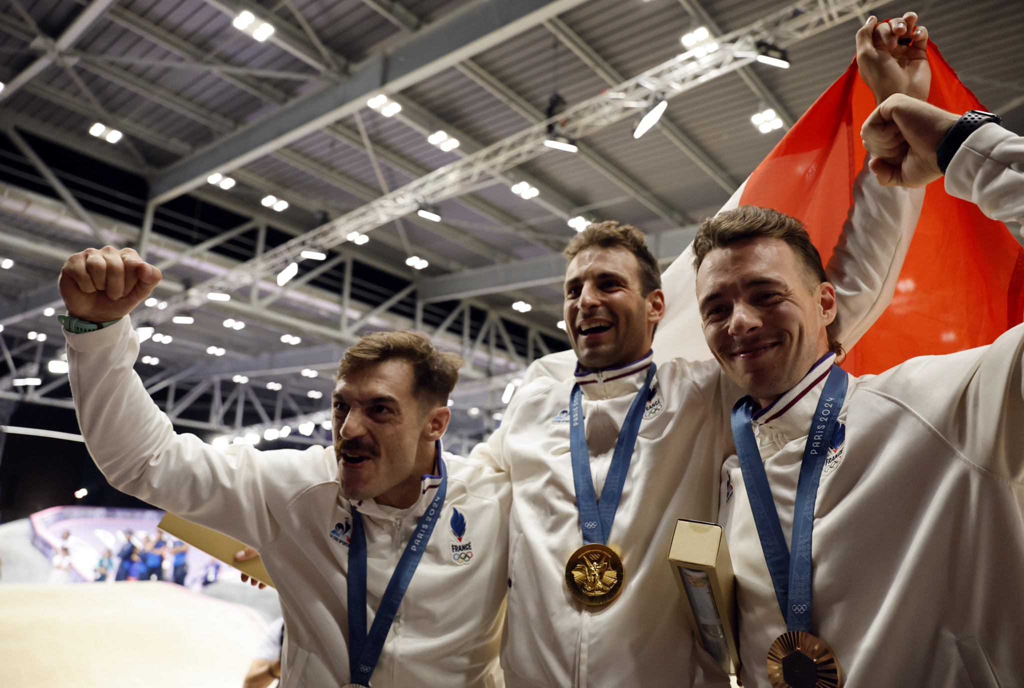 epa11520648 (L-R) Second placed silver medal winner Sylvain Andre of France, gold medal winner Joris Daudet of France and third placed bronze medal winner Romain Mahieu of France celebrate on the podium of the Men's Cycling BMX Racing competitions in the Paris 2024 Olympic Games, at the BMX Stadium in Saint-Quentin-en-Yvelines, France, 02 August 2024.  EPA/TOLGA AKMEN