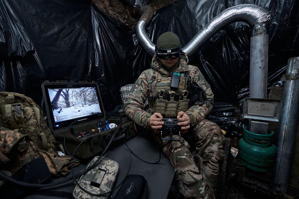 KUPIANSK FRONTLINE, UKRAINE - JANUARY 26: (EDITOR'S NOTE: No new use of feed image after February 27, 2024. After that date, image will need to be licensed from the website.)  A soldier from the FPV unit of the pilots of the Ukrainian army launches a kamikaze drone at the positions of the Russians on January 26, 2024 in Kupiansk Frontline, Ukraine. The Edelweiss Brigade (also spelled Edelveys), a specialized unit within the Ukrainian ground forces, is trying to fend off near-constant Russian attacks on Kupiansk, which is mere kilometers from the frontline. Ukrainian soldiers, mountain assault infantry, hold the front in the winter forest. (Photo by Kostiantyn Liberov/Libkos/Getty Images)