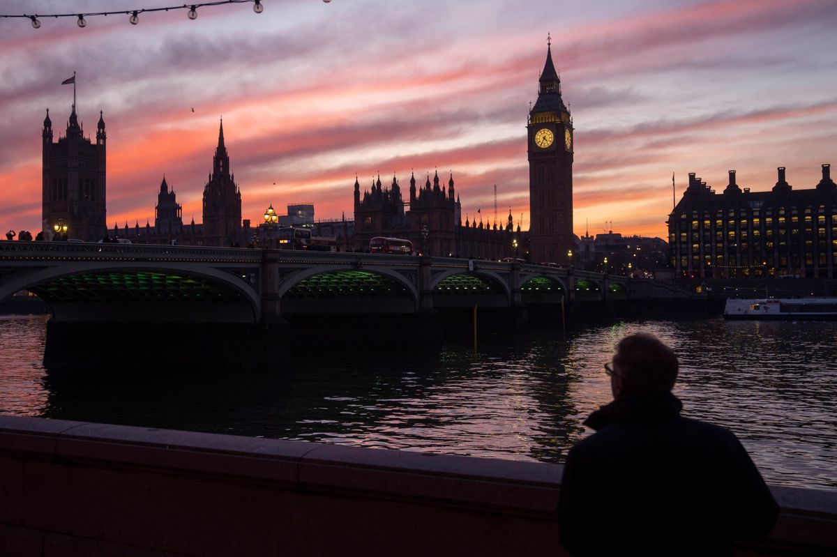 FILE - A man walks along the south bank of the River Thames backdropped by the Elizabeth Tower, known as Big Ben, of the Houses of Parliament, in London, Tuesday, Jan. 17, 2023.  As in-person classes resume around the globe, American high school seniors are increasingly applying to undergrad programs abroad in pursuit of cheaper (or free) tuition and more focused degree programs. But where your wallet is concerned, attending college abroad isn’t automatically the best bet.  (AP Photo/Kin Cheung, File)