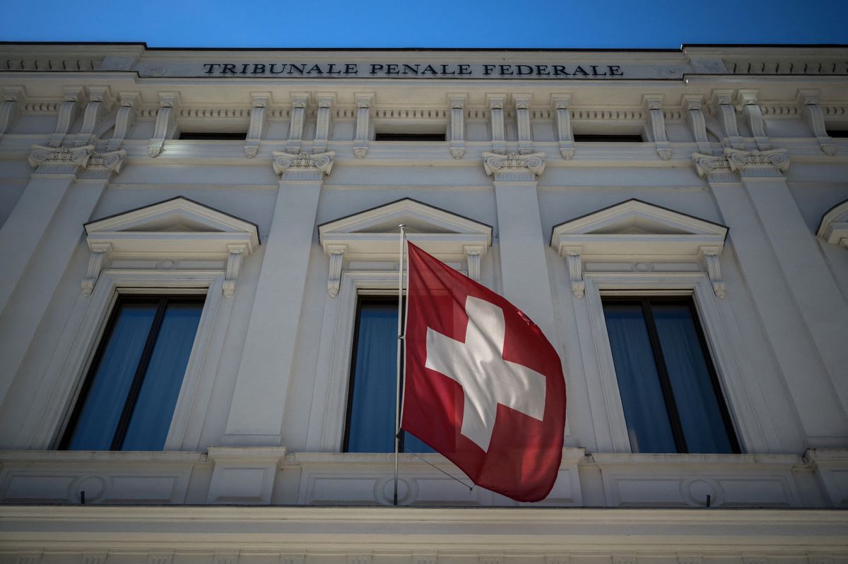 A Swiss flag floats in the front of Switzerland's Federal Criminal Court in the southern Switzerland city of Bellinzona, on July 8, 2022. Sepp Blatter and Michel Platini, once the chiefs of world and European football, were acquitted over a suspected fraudulent payment that shook the sport and torpedoed their time at the top. (Photo by Fabrice COFFRINI / AFP)