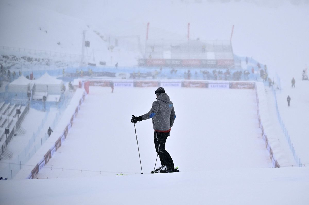 A man stands at the bottom of the Zermatt-Cervinia track on November 10, 2023 after the men's downhill training was cancelled due to bad weather during the FIS Alpine Ski World Cup in Italy. (Photo by Marco BERTORELLO / AFP)