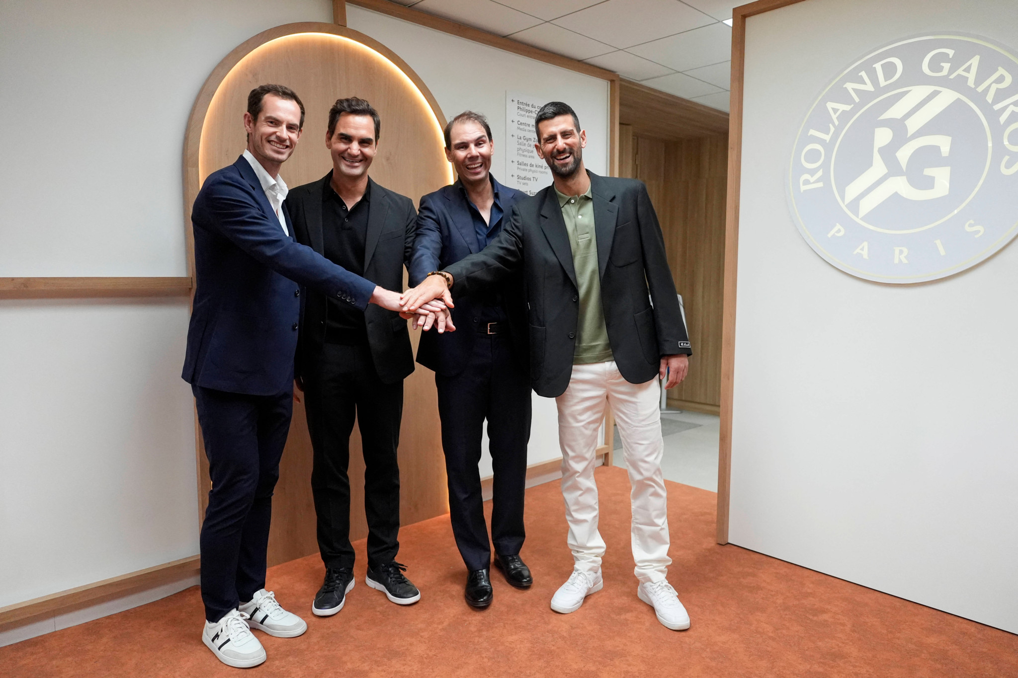 Andy Murray, Roger Federer, Rafael Nadal and Novak Djokovic shaking hands during a tribute event for Nadal at the French Open in Paris 2025.