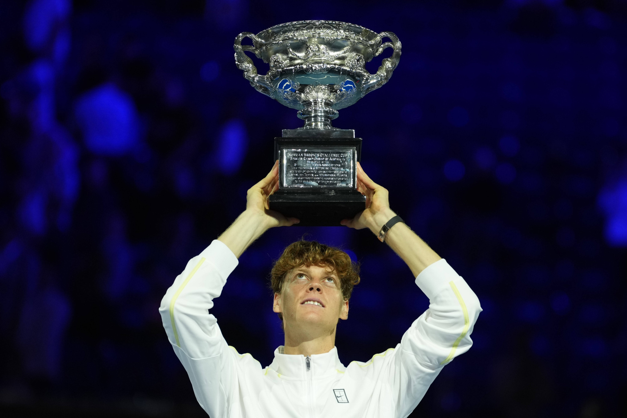 Jannik Sinner holds up the 2025 Australian Open trophy after his victory in the men's final against Alexander Zverev in Melbourne.