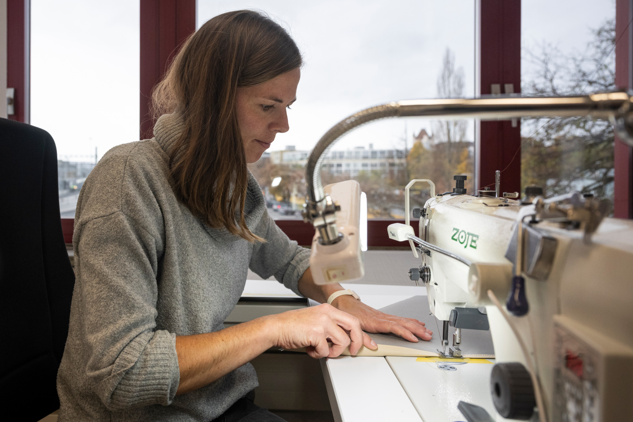 Barbara Saurer näht an einer Nähmaschine in einer Manufaktur. Sie ist an der Produktion von mobilen Outdoor-Saunazelten in Thun beteiligt.
