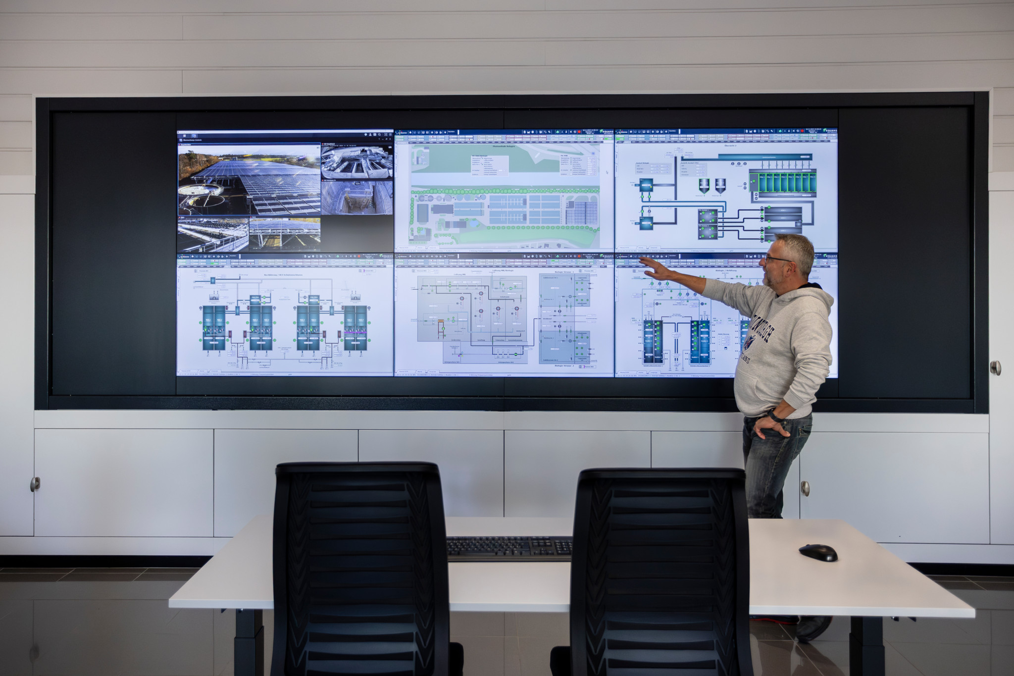 Ingo Schoppe präsentiert das Kontrollsystem einer faltbaren Photovoltaikanlage auf einer grossen Bildschirmwand in der ARA Thunersee, Uetendorf.