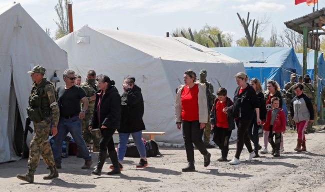 Civilians who left the area near Azovstal steel plant in Mariupol walk at a temporary accommodation centre during Ukraine-Russia conflict in the village of Bezimenne in the Donetsk Region, Ukraine May 1, 2022. REUTERS/Alexander Ermochenko