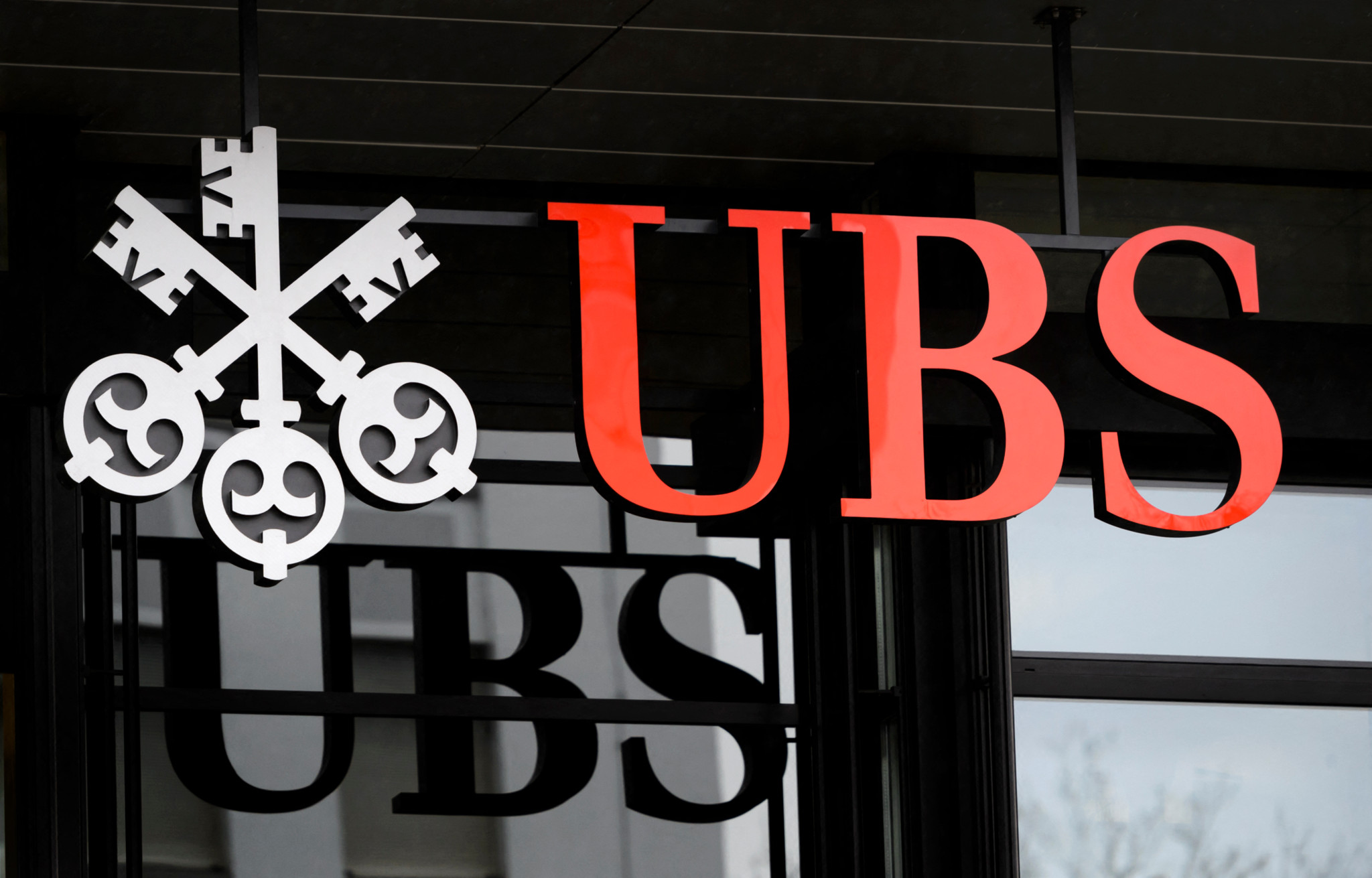 (FILES) This photograph taken on January 12, 2016, shows the logo of the Swiss global financial services company UBS at the entrance of a branch's building in Zurich. France's top appeals court upheld a tax fraud conviction against UBS on November 15, 2023, but ordered a third trial to determine how much the Swiss bank should be fined.
Switzerland's largest bank had been condemned by an appeals court in December 2021 and ordered to pay a total of 1.8 billion euros ($1.9 billion). (Photo by FABRICE COFFRINI / AFP)