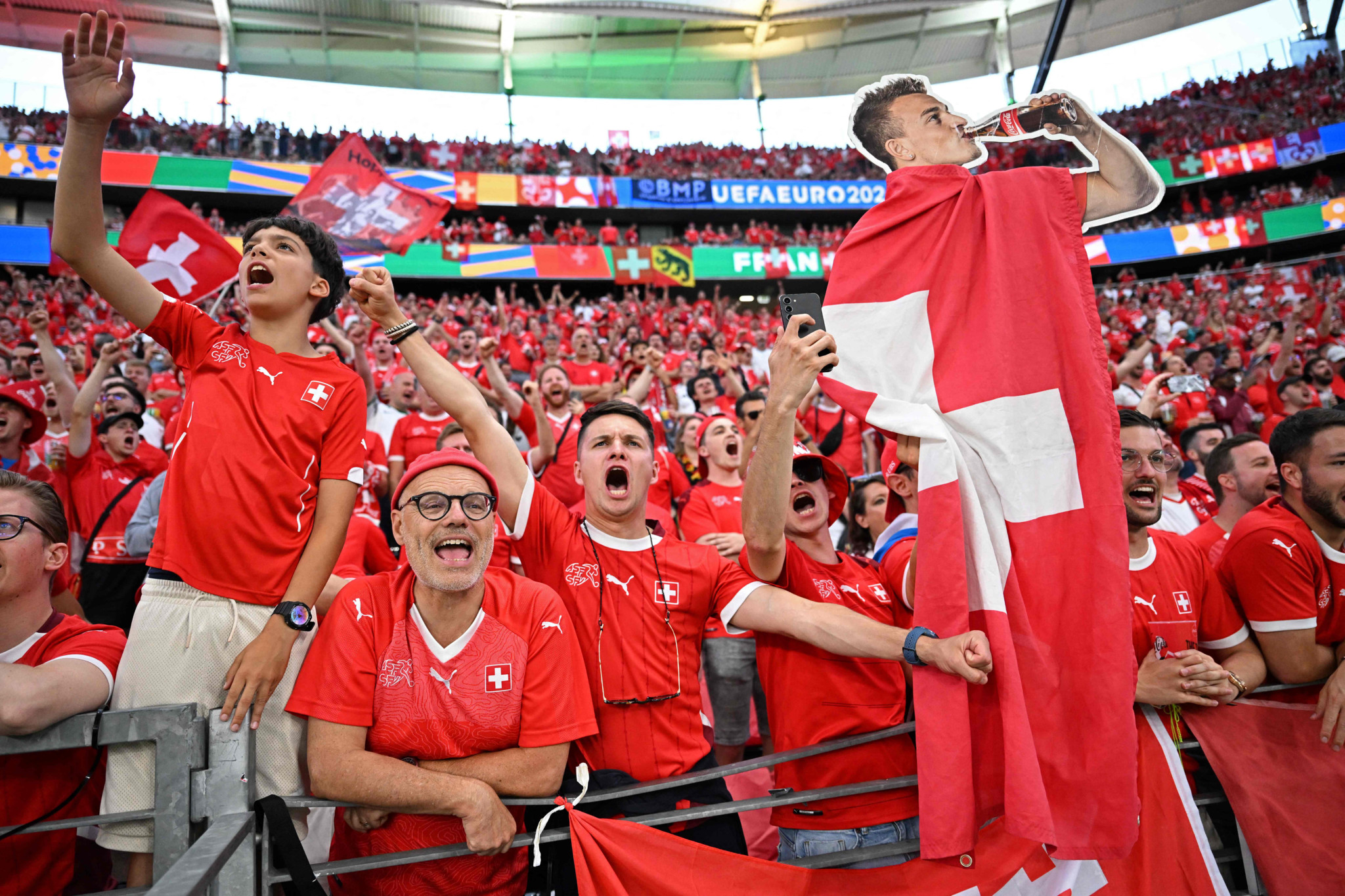 Switzerland fans hold up a cardboard cutout of Switzerland's midfielder #23 Xherdan Shaqiri prior to the UEFA Euro 2024 Group A football match between Switzerland and Germany at the Frankfurt Arena in Frankfurt am Main on June 23, 2024. (Photo by Kirill KUDRYAVTSEV / AFP)
