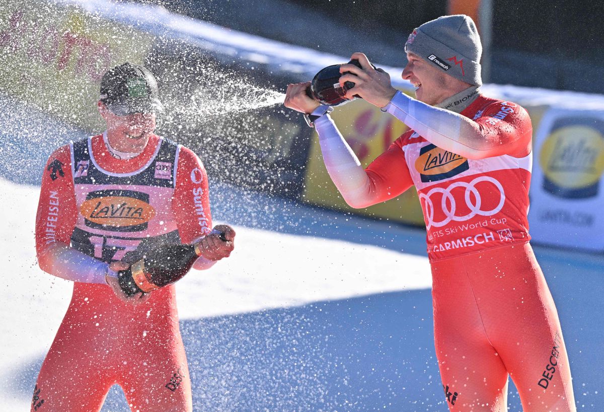 Winner Switzerland's Marco Odermatt (R) and third placed Switzerland's Franjo Von Allmen celebrate with  champagne after the men's Super G event of the FIS Alpine Skiing World Cup in Garmisch-Partenkirchen, southern Germany, on January 28, 2024. (Photo by KERSTIN JOENSSON / AFP)