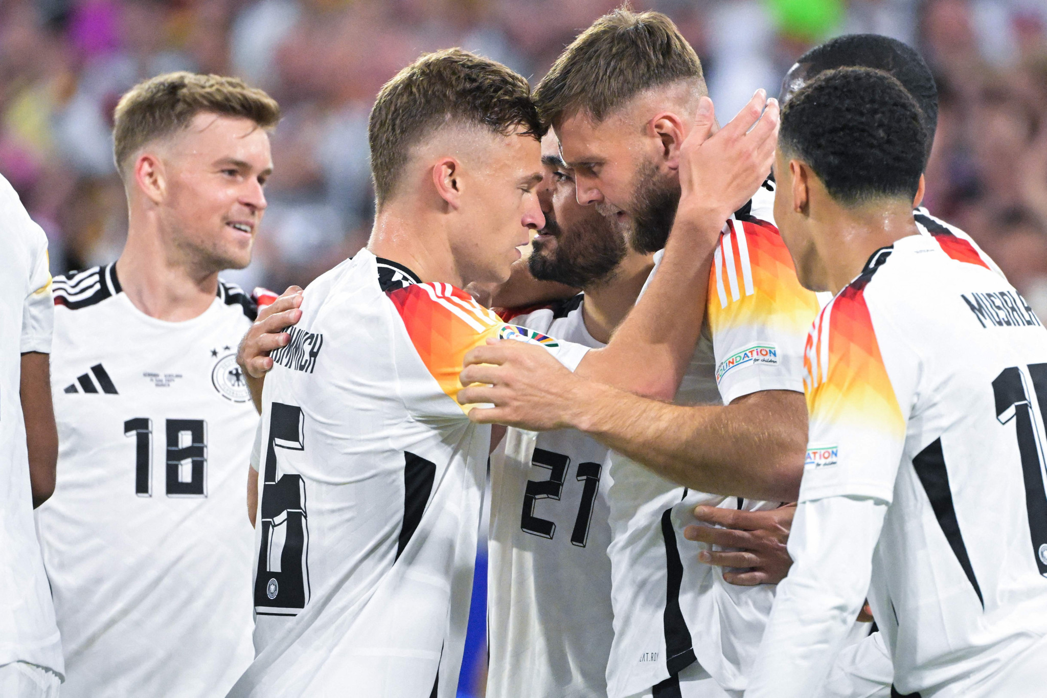 Germany's forward #09 Niclas Fuellkrug (centre right) celebrates with teammates after scoring his team's fourth goal during the UEFA Euro 2024 Group A football match between Germany and Scotland at the Munich Football Arena in Munich on June 14, 2024. (Photo by DAMIEN MEYER / AFP)