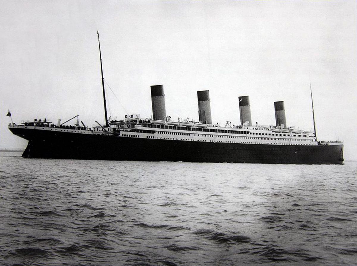 Le RMS Titanic en avril 1912 naviguant sur la mer avec ses quatre cheminées distinctives.