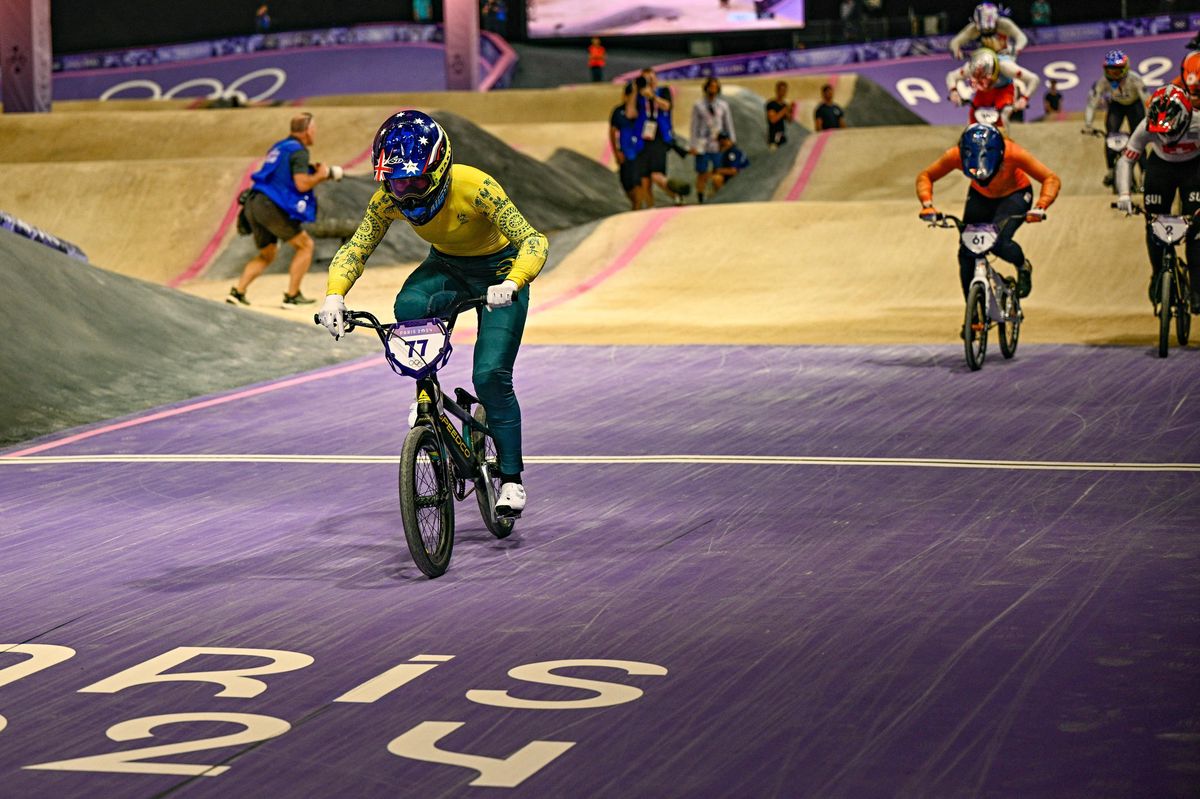 Australia's #77 Saya Sakakibara crosses the finish line to win the Women's Cycling BMX Racing final during the Paris 2024 Olympic Games in Saint-Quentin-en-Yvelines, on August 2, 2024. (Photo by JULIEN DE ROSA / AFP)